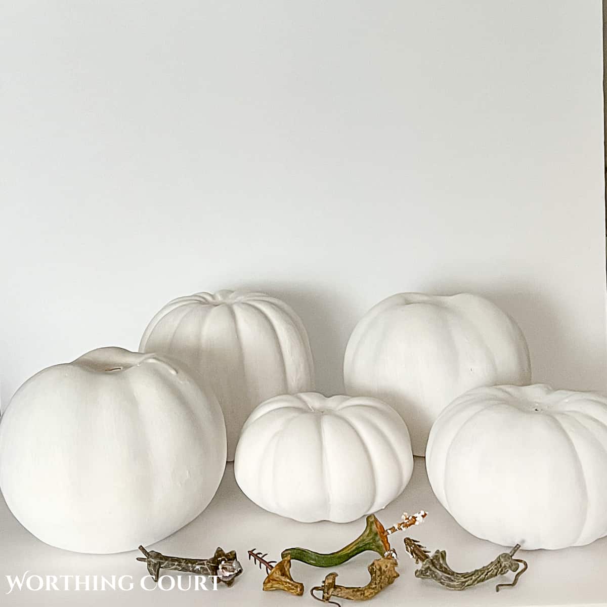 faux pumpkins painted white to make diy chinoiserie pumpkins