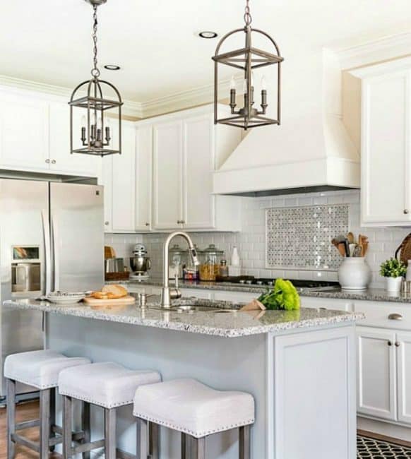 kitchen with white cabinets and a gray island with counter height stools