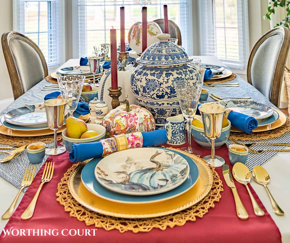 blue and white thanksgiving table setting with touches of burgundy