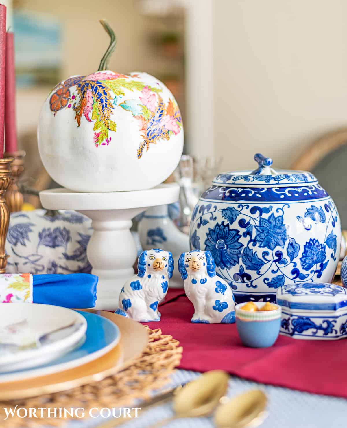 blue and white thanksgiving table setting with touches of burgundy