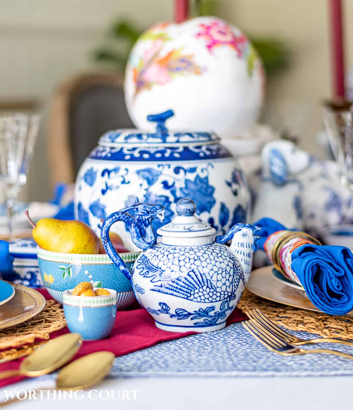 blue and white thanksgiving table setting with touches of burgundy