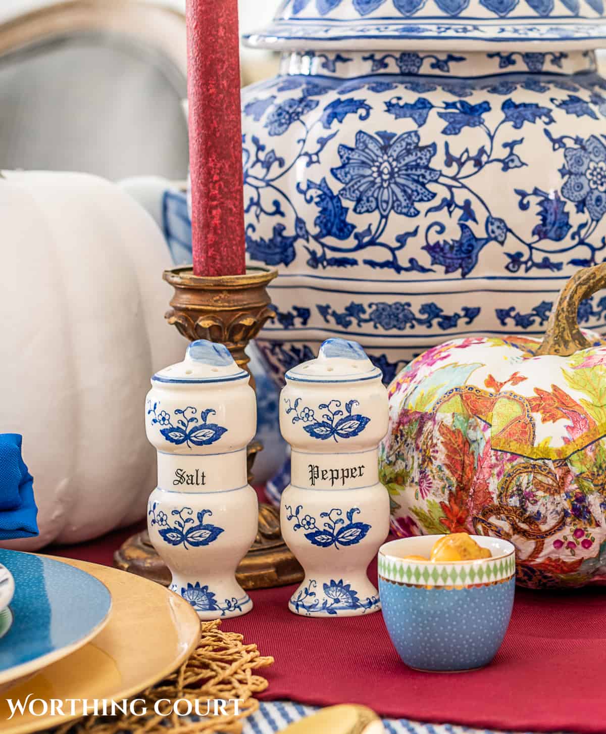 blue and white thanksgiving table setting with touches of burgundy