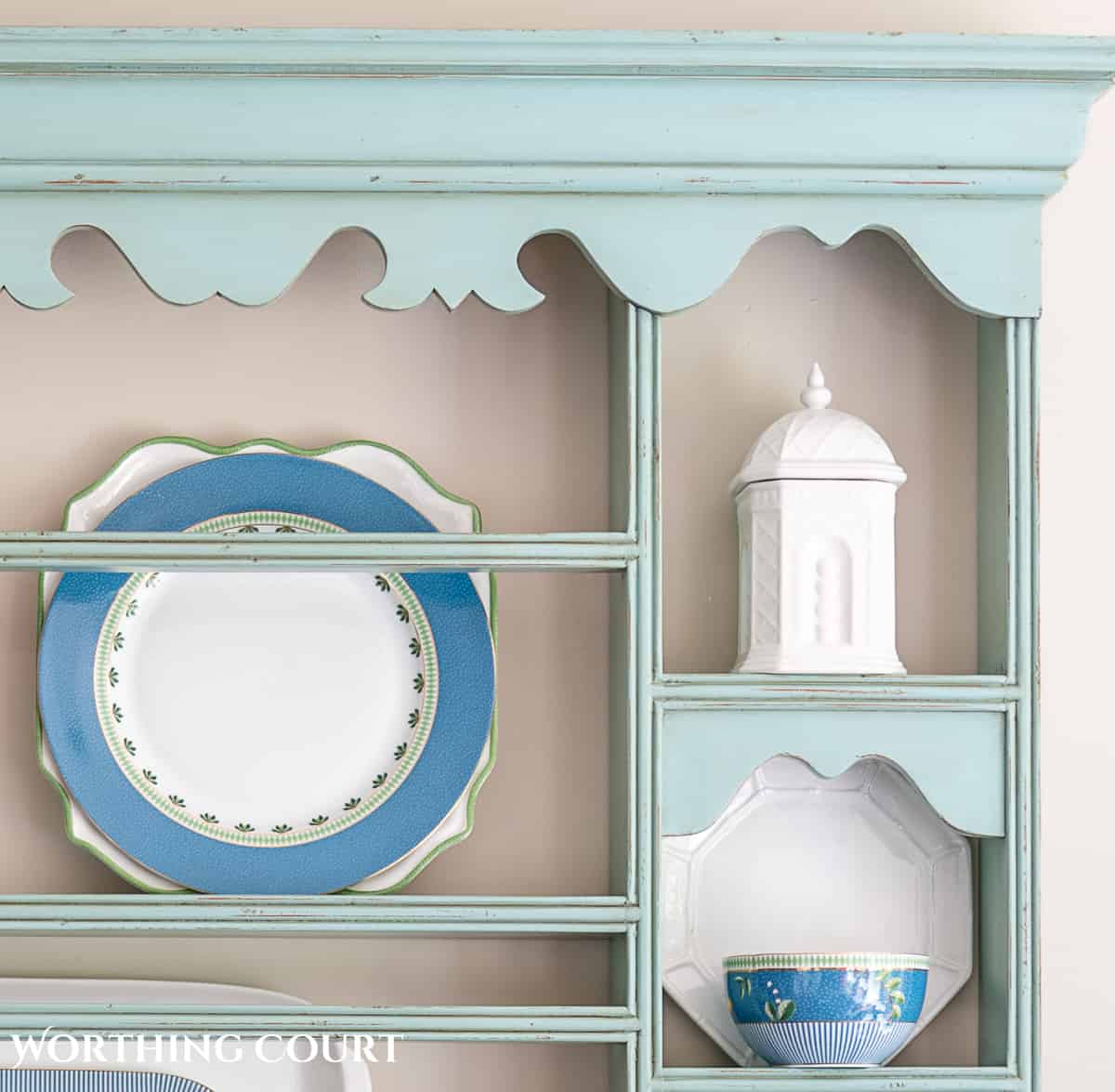 blue plate rack with blue and white dishes and tips for how to decorate a plate display rack with your favorite items