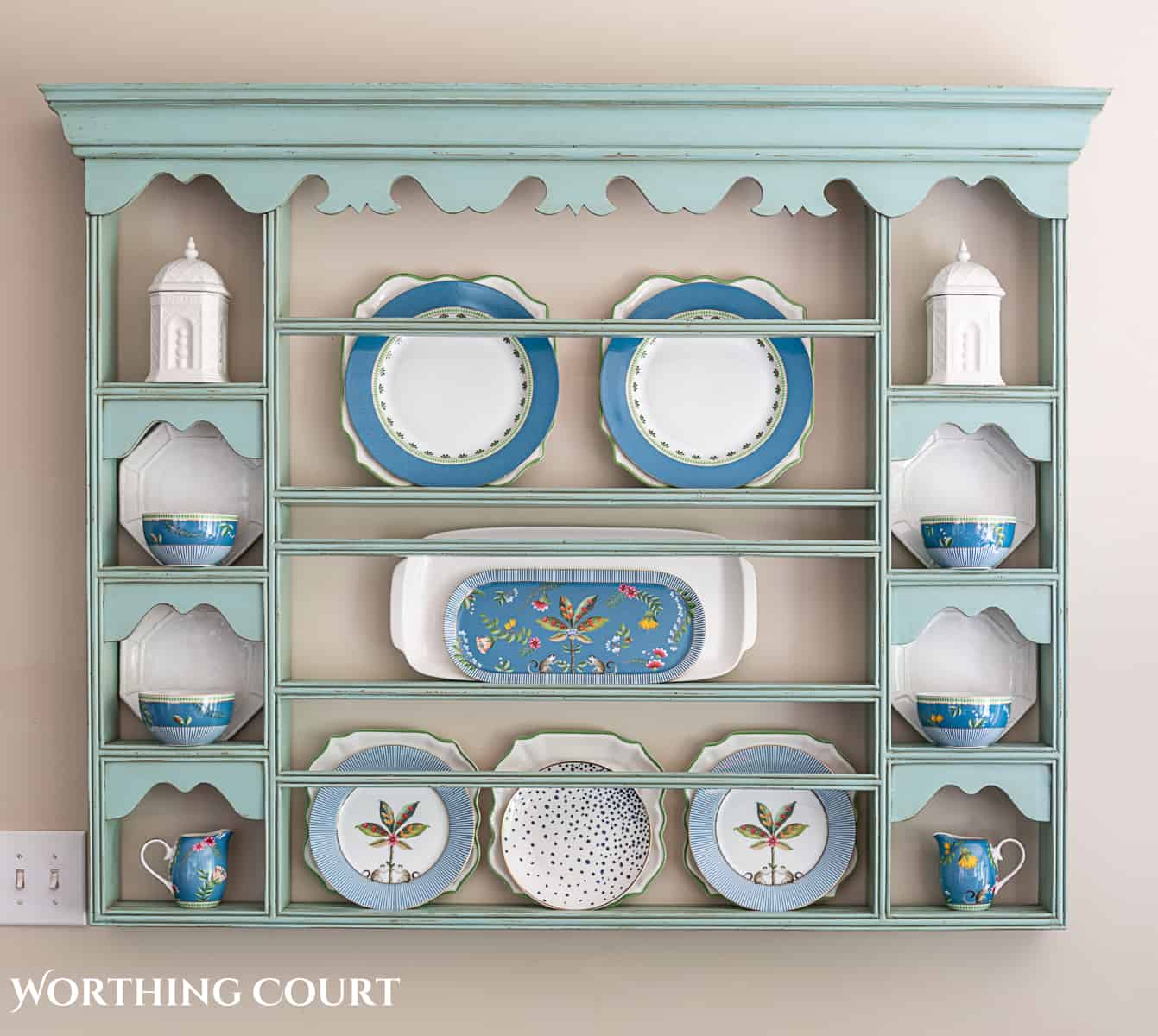 blue plate rack with blue and white dishes and tips for how to decorate a plate display rack with your favorite items