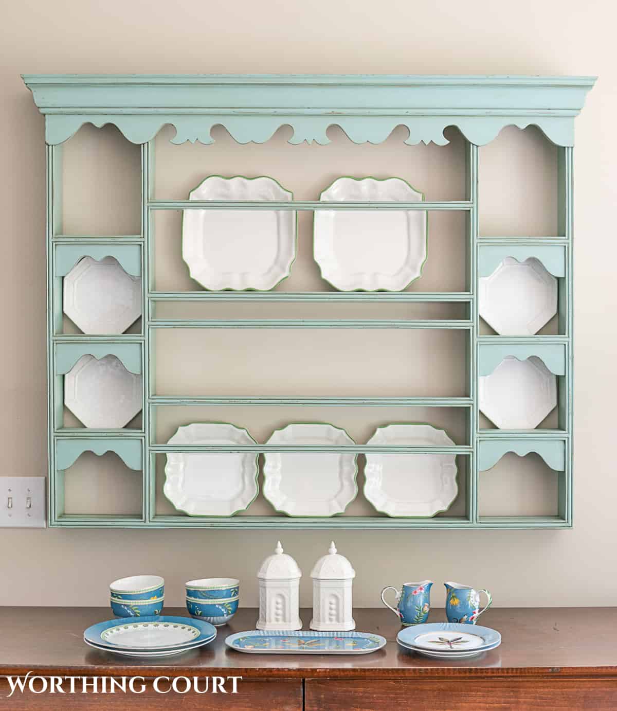 blue plate rack with blue and white dishes and tips for how to decorate a plate display rack with your favorite items