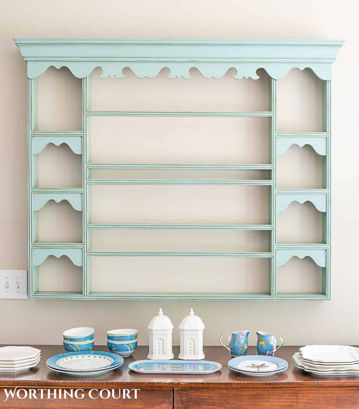 blue plate rack with blue and white dishes and tips for how to decorate a plate display rack with your favorite items