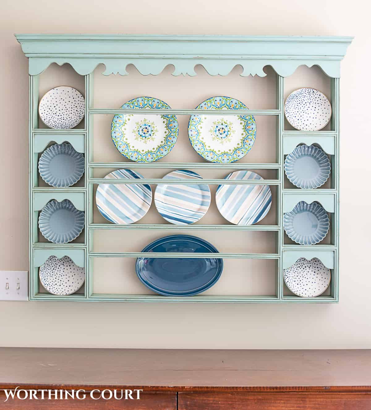 blue plate rack with blue and white dishes and tips for how to decorate a plate display rack with your favorite items