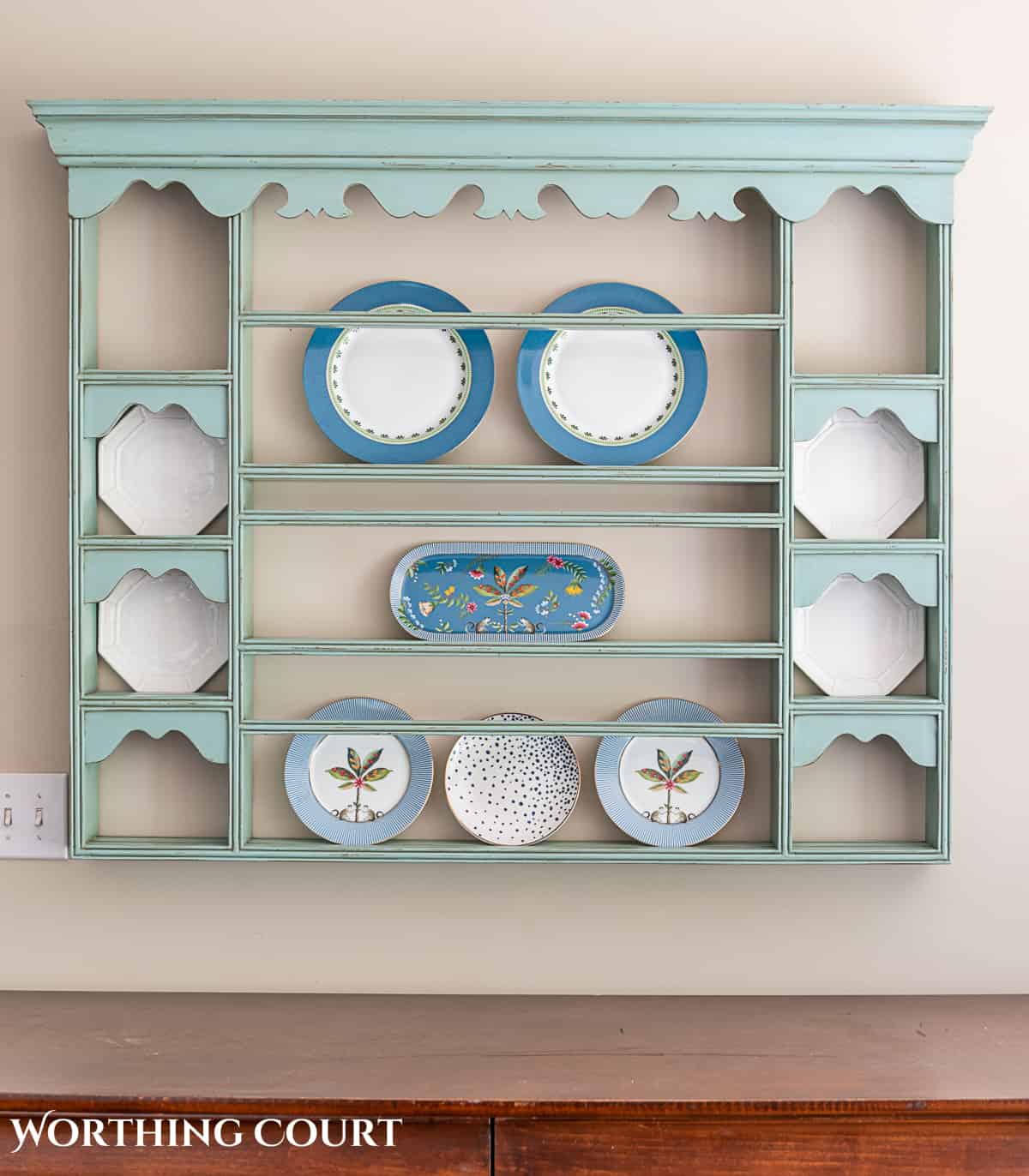 blue plate rack with blue and white dishes and tips for how to decorate a plate display rack with your favorite items