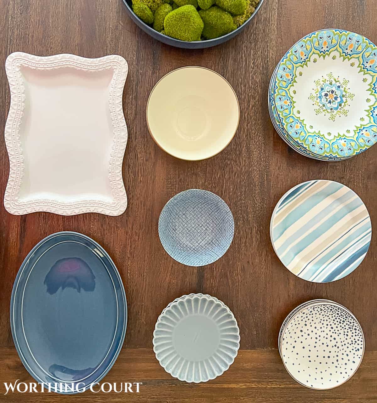 blue and white dishes on a table to show how to decorate a plate display rack