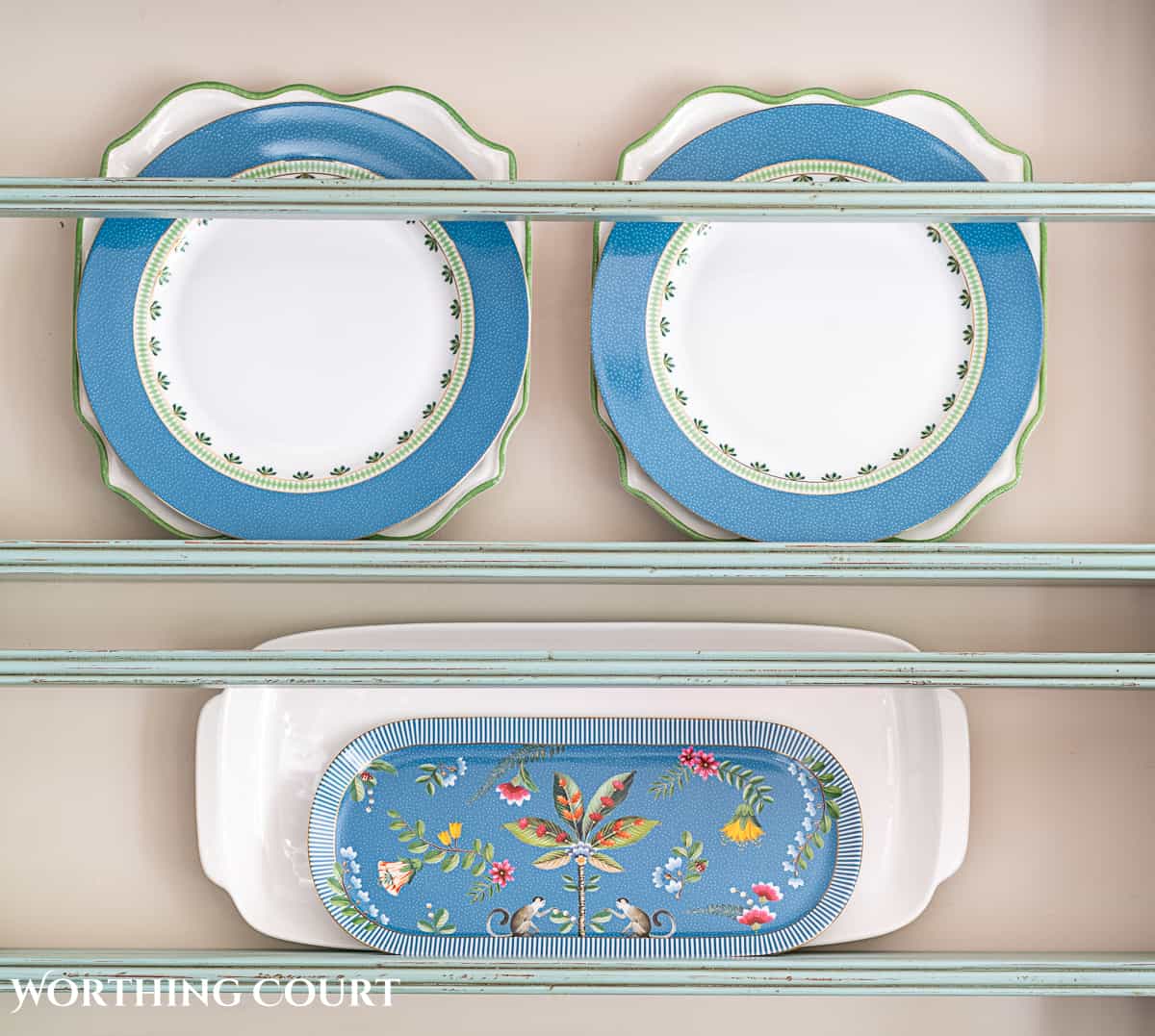 blue plate rack with blue and white dishes and tips for how to decorate a plate display rack with your favorite items