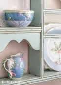 blue plate rack with blue and white dishes and tips for how to decorate a plate display rack with your favorite items