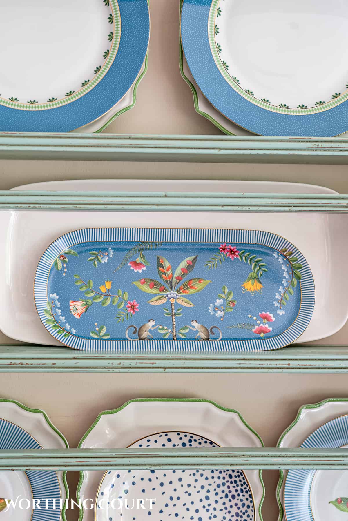 blue plate rack with blue and white dishes and tips for how to decorate a plate display rack with your favorite items