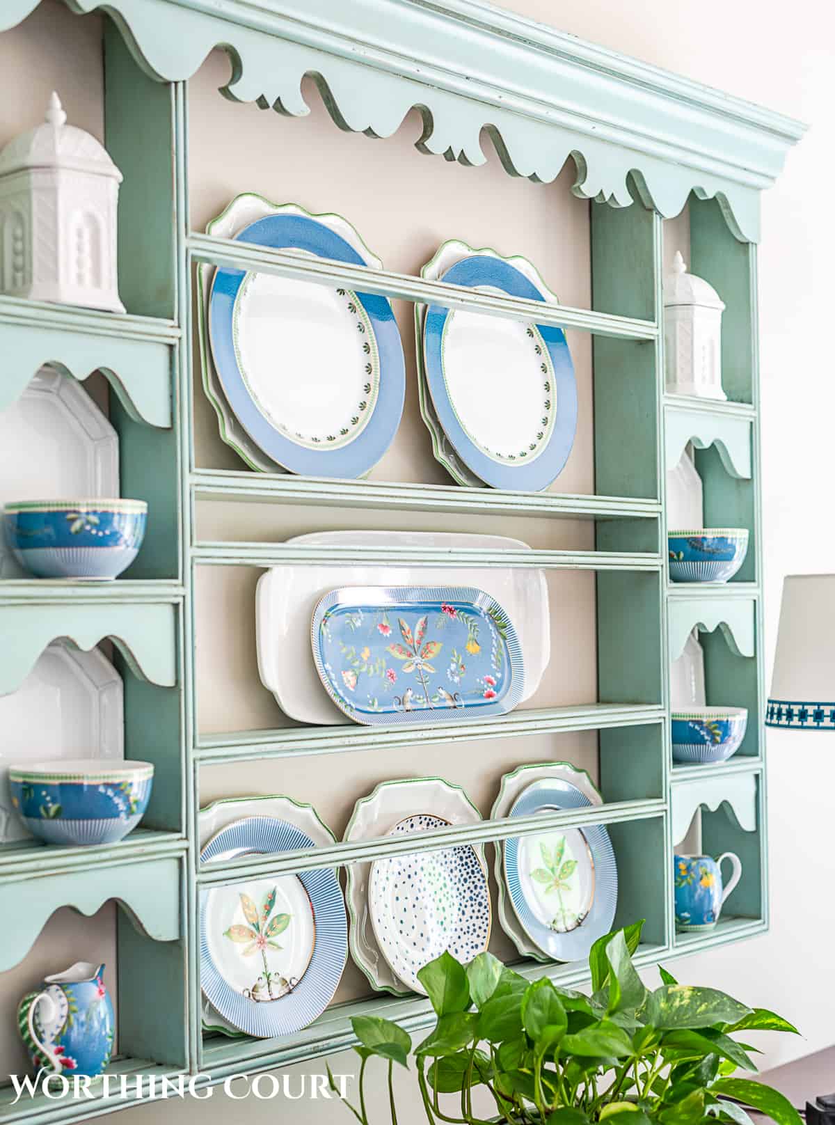 blue plate rack with blue and white dishes and tips for how to decorate a plate display rack with your favorite items