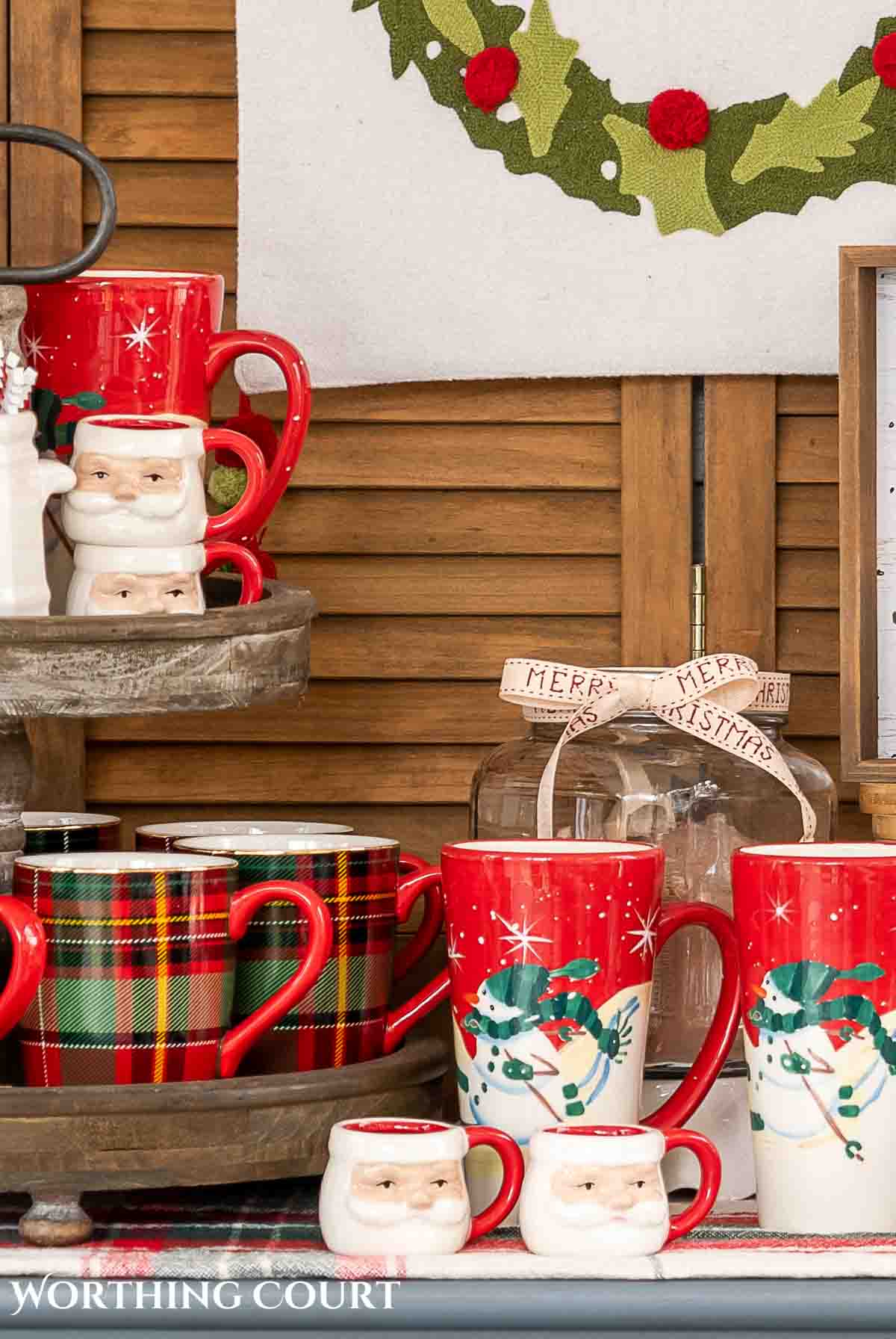 plaid and snowman mugs on a Christmas hot chocolate bar