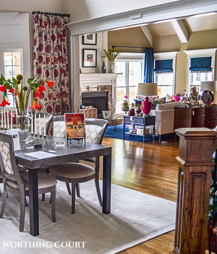 view looking across dining table into a family room with vaulted ceiling
