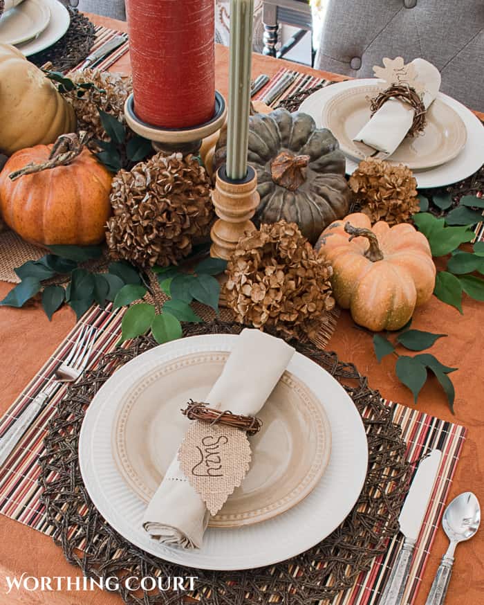Thanksgiving table setting with fall colors and white dishes