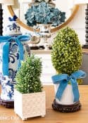 Christmas centerpiece with blue and white ginger jar and topiaries accented with French blue ribbon