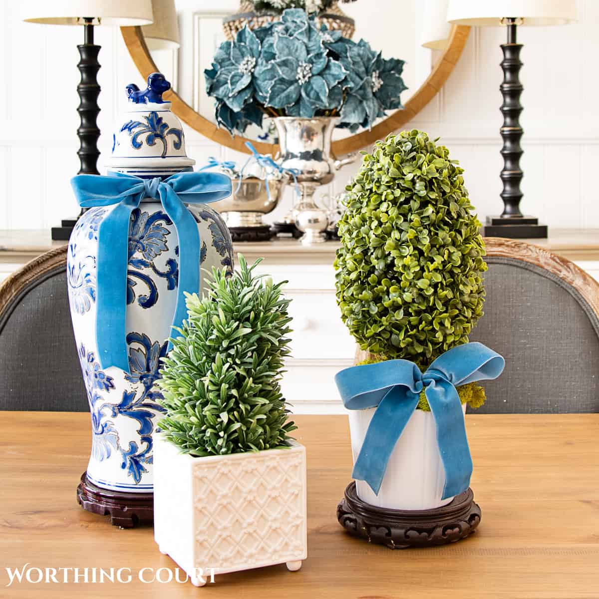 Christmas centerpiece with blue and white ginger jar and topiaries accented with French blue ribbon