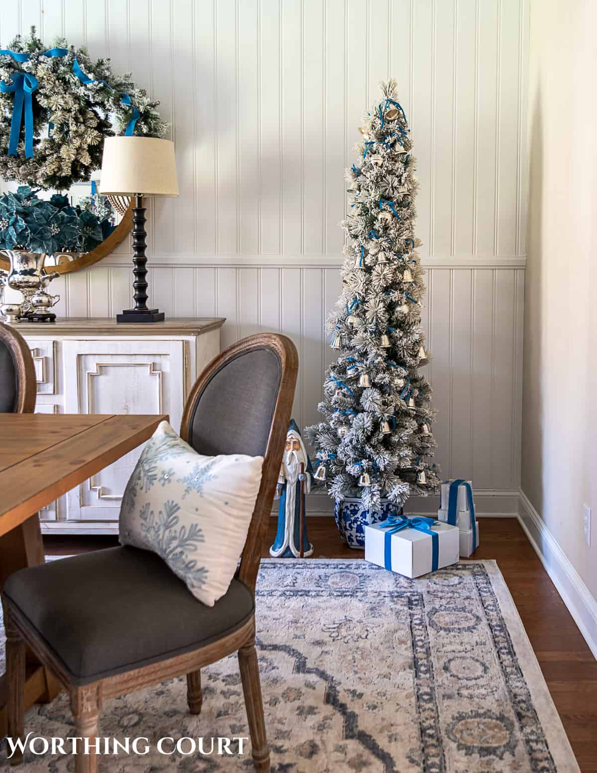 flocked pencil Christmas tree decorated with French blue and silver ornaments and ribbon