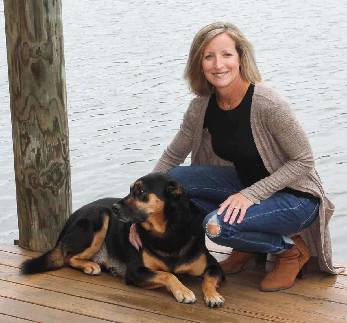 woman on a dock with a dog