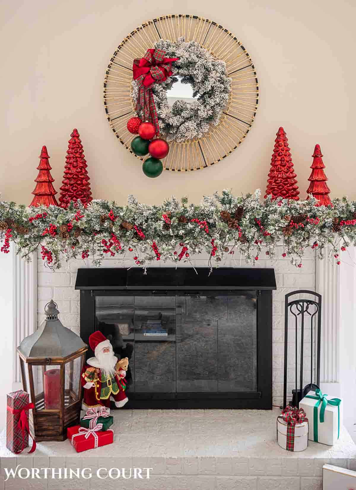 Christmas tree, fireplace and living room decorated for Christmas with red green and gold decorations