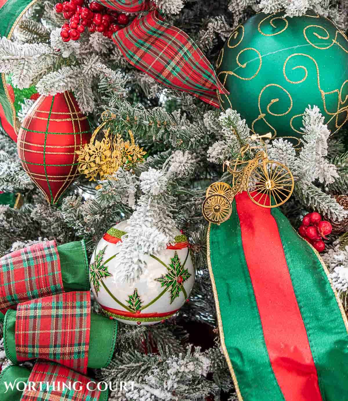 Christmas tree, fireplace and living room decorated for Christmas with red green and gold decorations