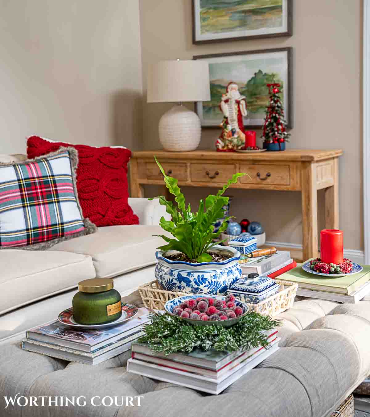 Christmas tree, fireplace and living room decorated for Christmas with red green and gold decorations