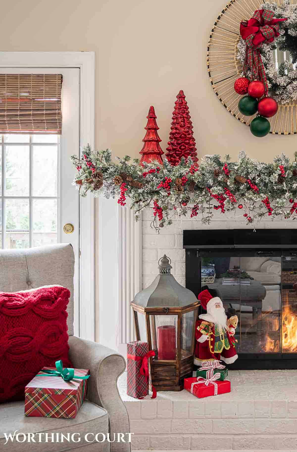 Christmas tree, fireplace and living room decorated for Christmas with red green and gold decorations