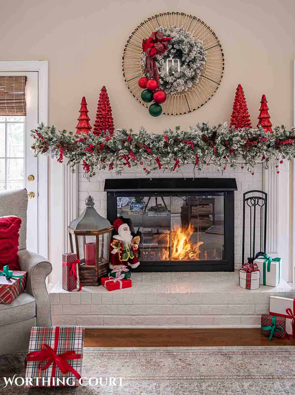 Christmas tree, fireplace and living room decorated for Christmas with red green and gold decorations