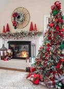 Christmas tree, fireplace and living room decorated for Christmas with red green and gold decorations