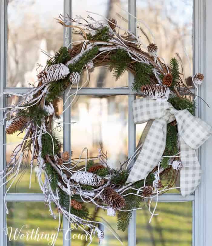 winter wreath hanging on a glass door