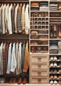 a small closet with an organizer filled with mens shirts and shoes