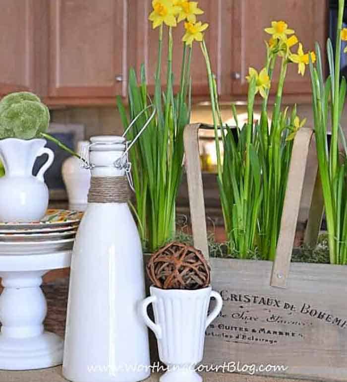 white accessories and daffodils on a kitchen counter