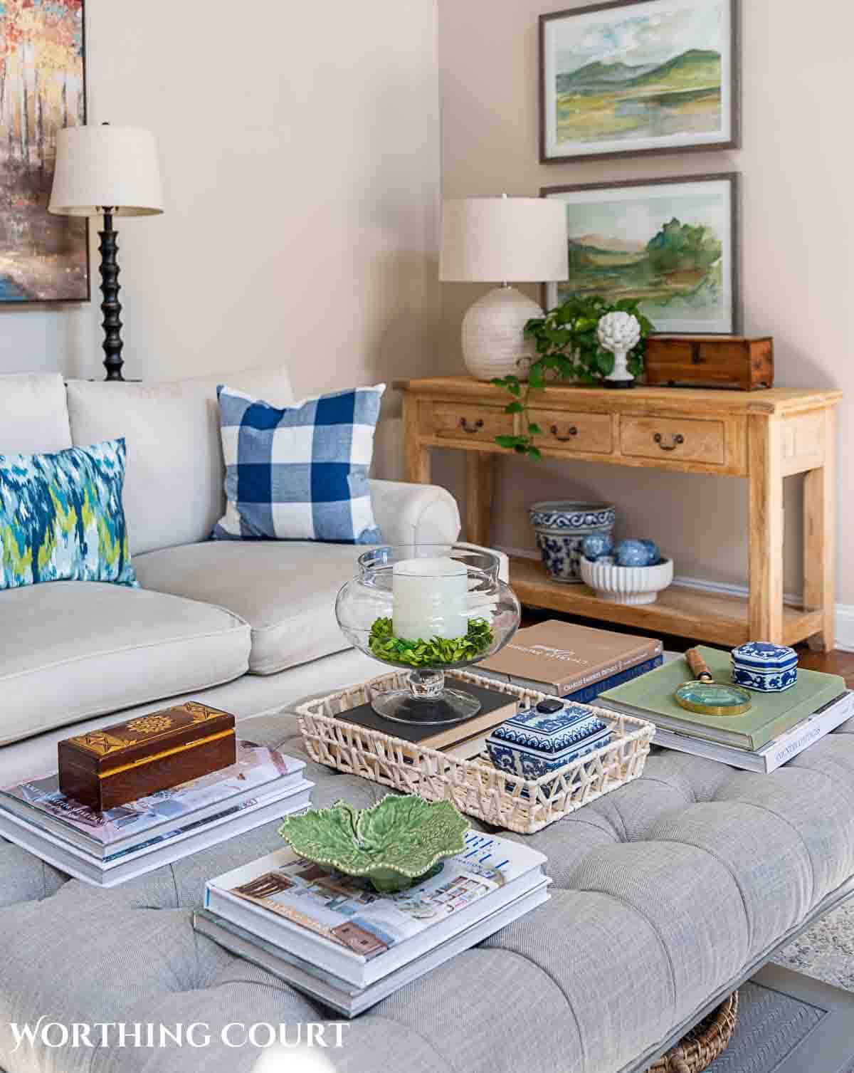 upholstered coffee table decorated with greenery and other accessories for spring
