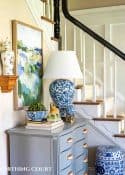 foyer with gray chest and spring decorations and greenery