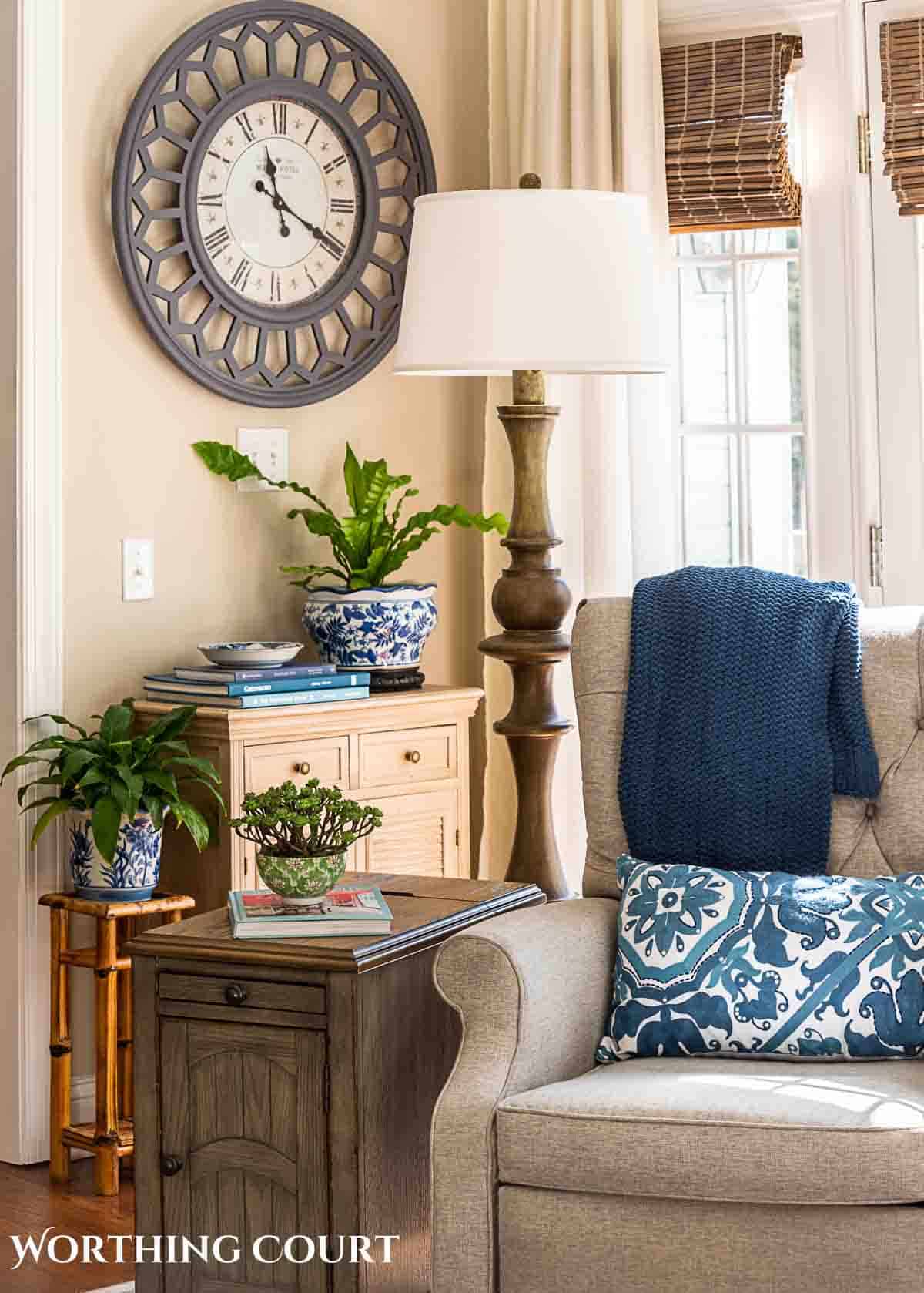 end table and small chest with spring decorations and greenery in planters