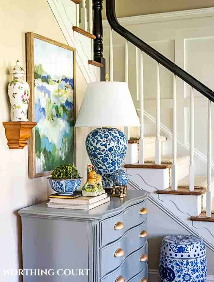 foyer with gray chest and spring decorations and greenery