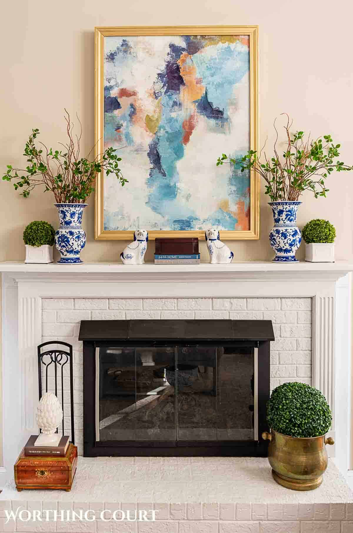 white brick fireplace and abstract art