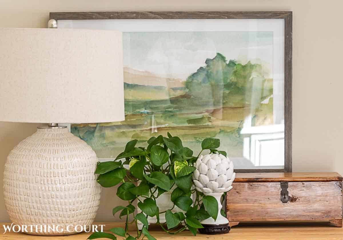 abstract wall art hanging above a console table