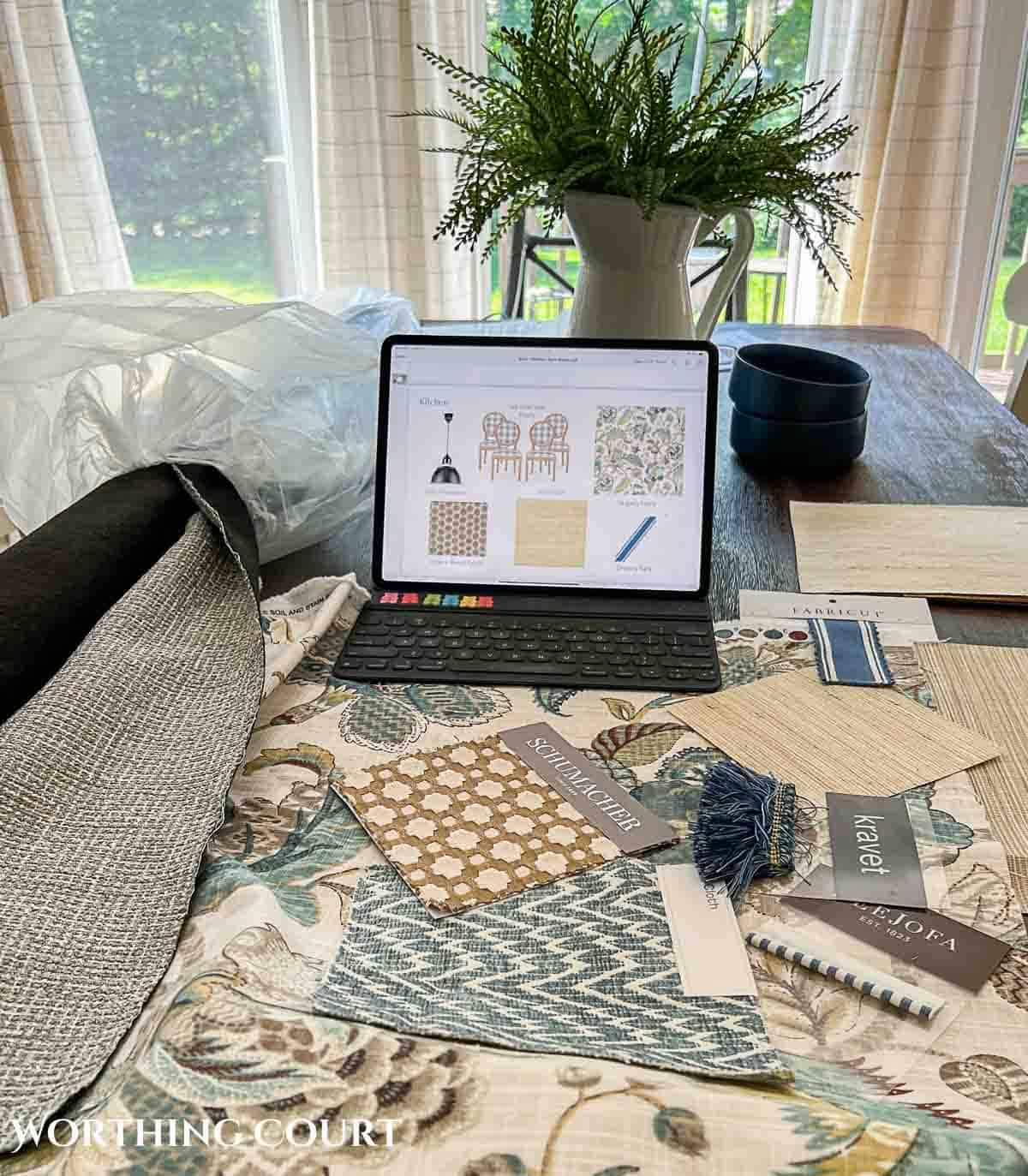 fabric swatches laid out on a table by hired interior designer