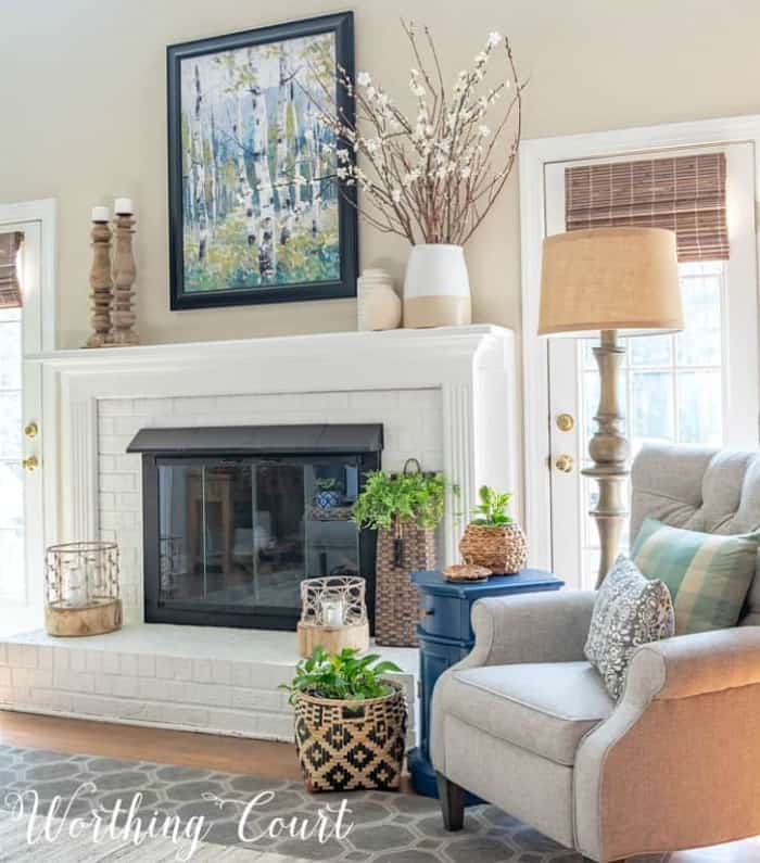 white brick fireplace and mantel decorated for summer