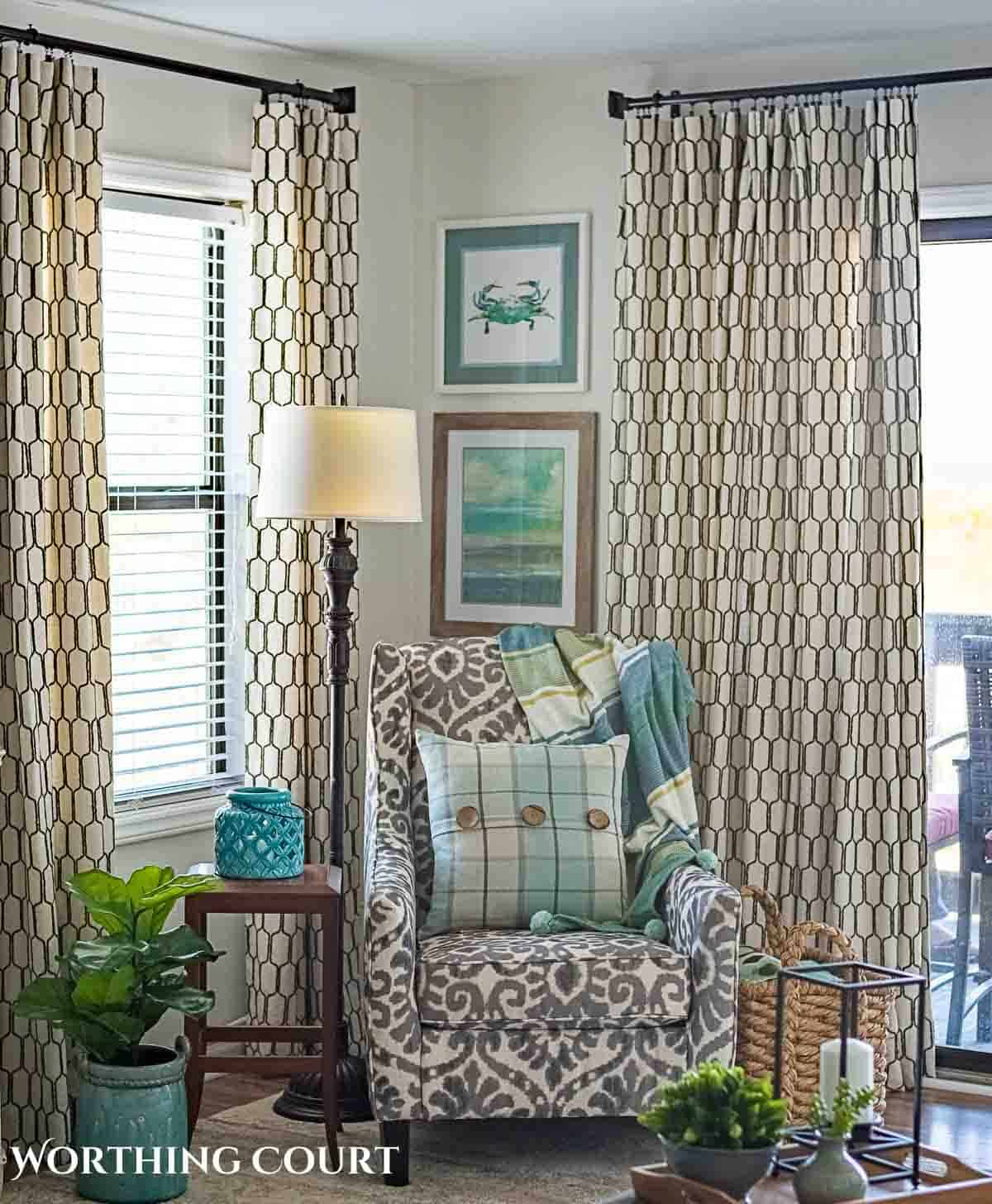 gray and white arm chair in a living room corner decorated with coastal accessories