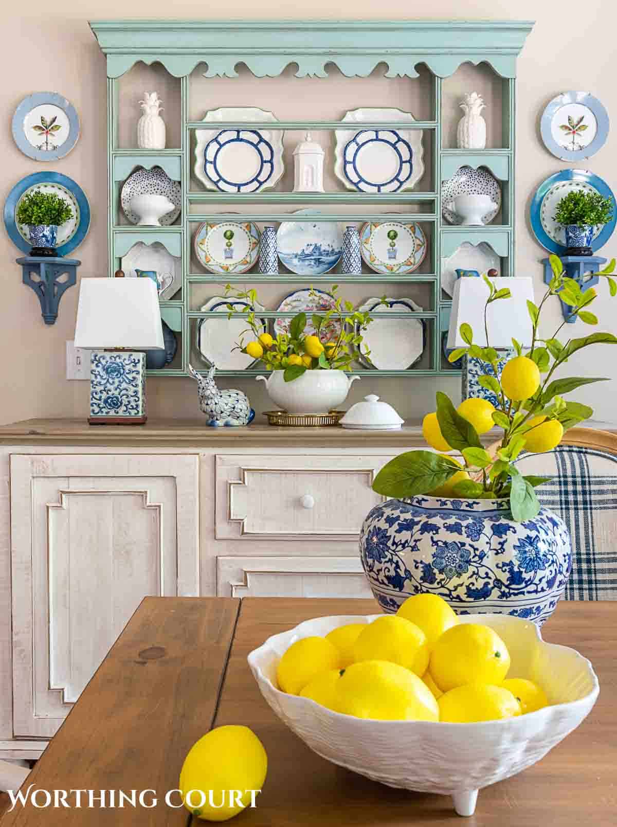 plate rack decorated for summer with blue and white plates and lemons in a bowl