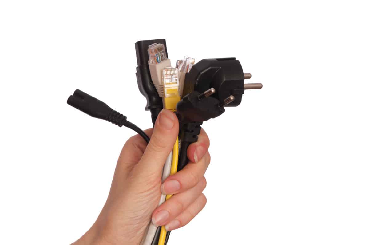 several types of electric cords in a person's hand