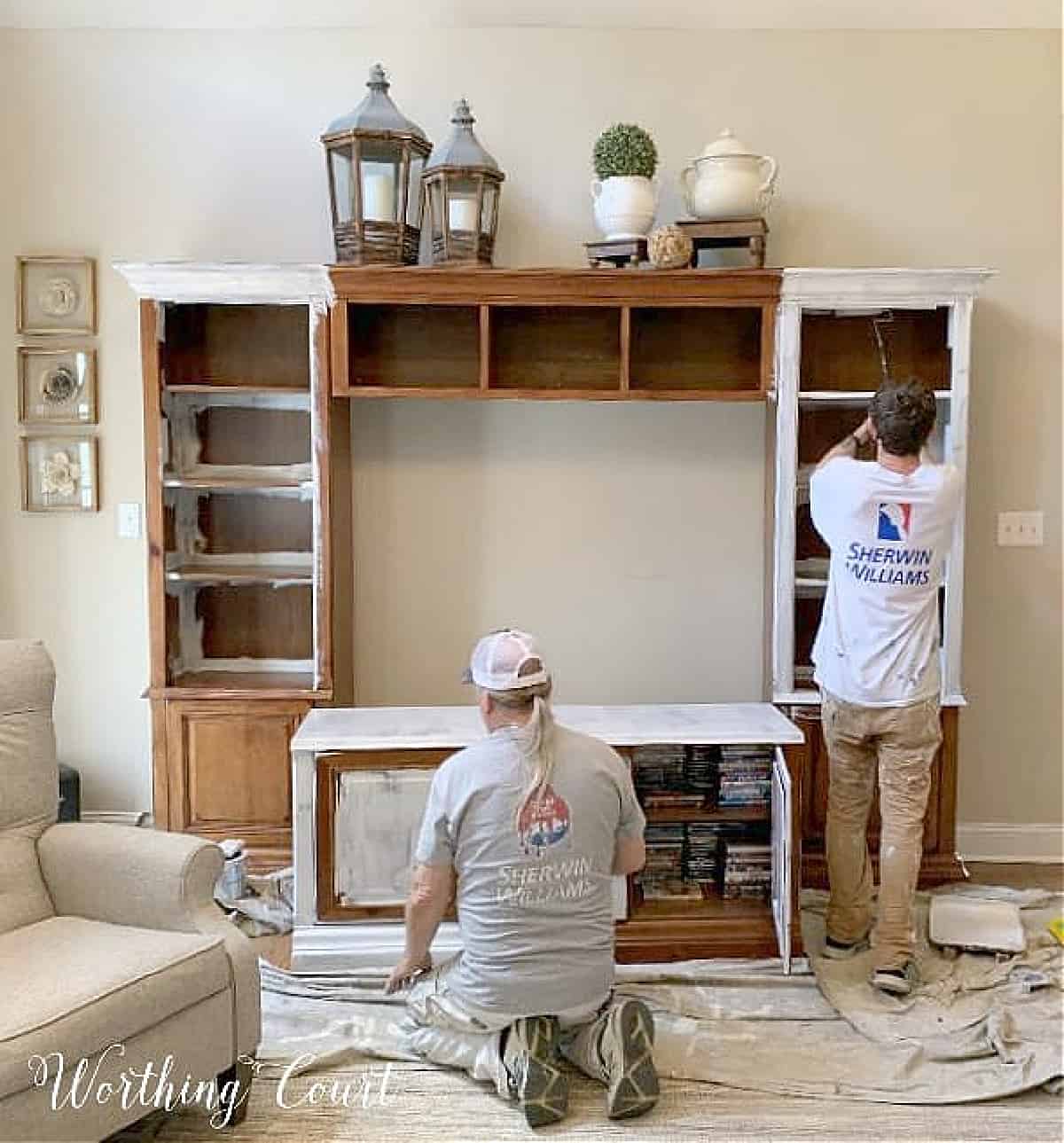 wood entertainment center in the process of being painted white