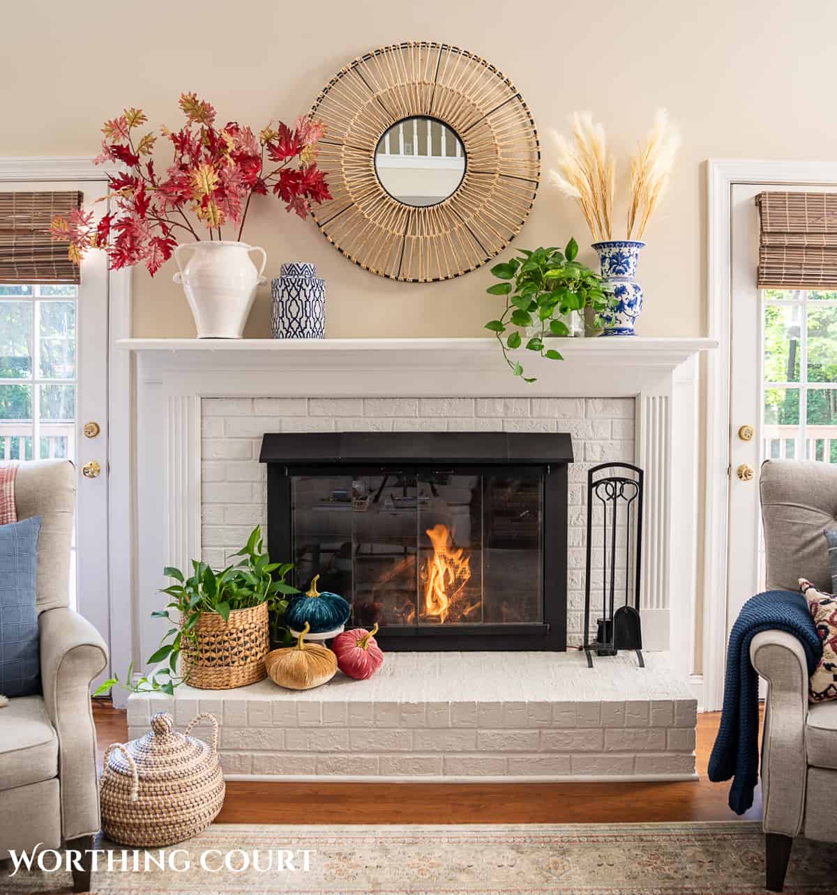 fall decorations on a white brink fireplace and mantel