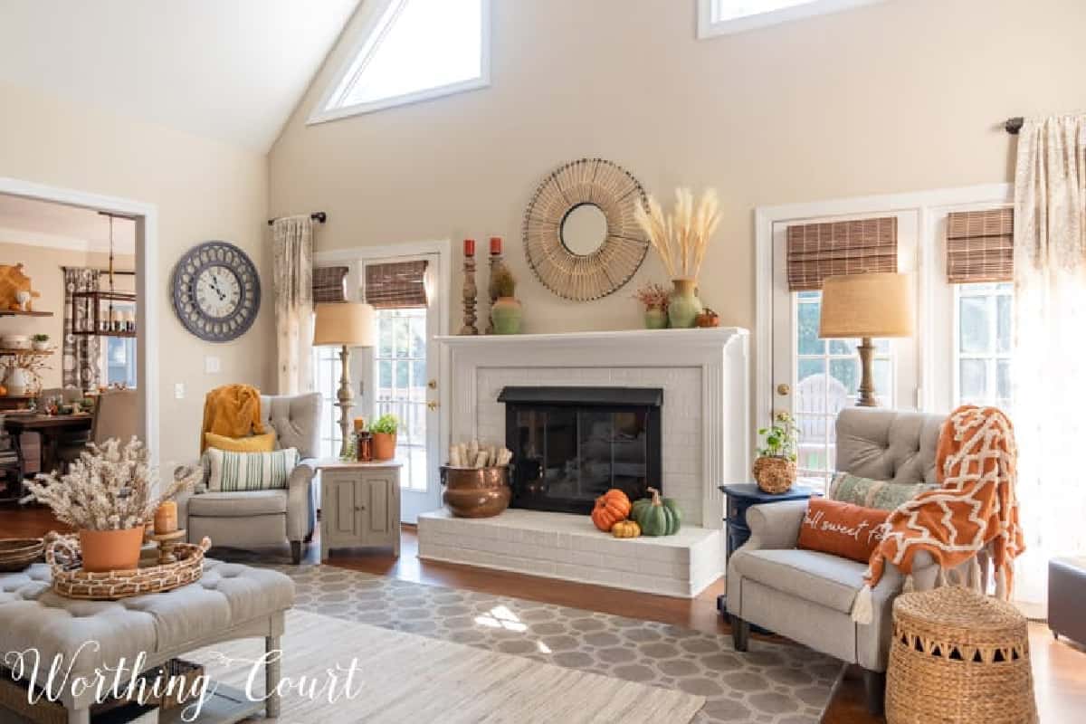 fall decorations on a white brink fireplace and mantel