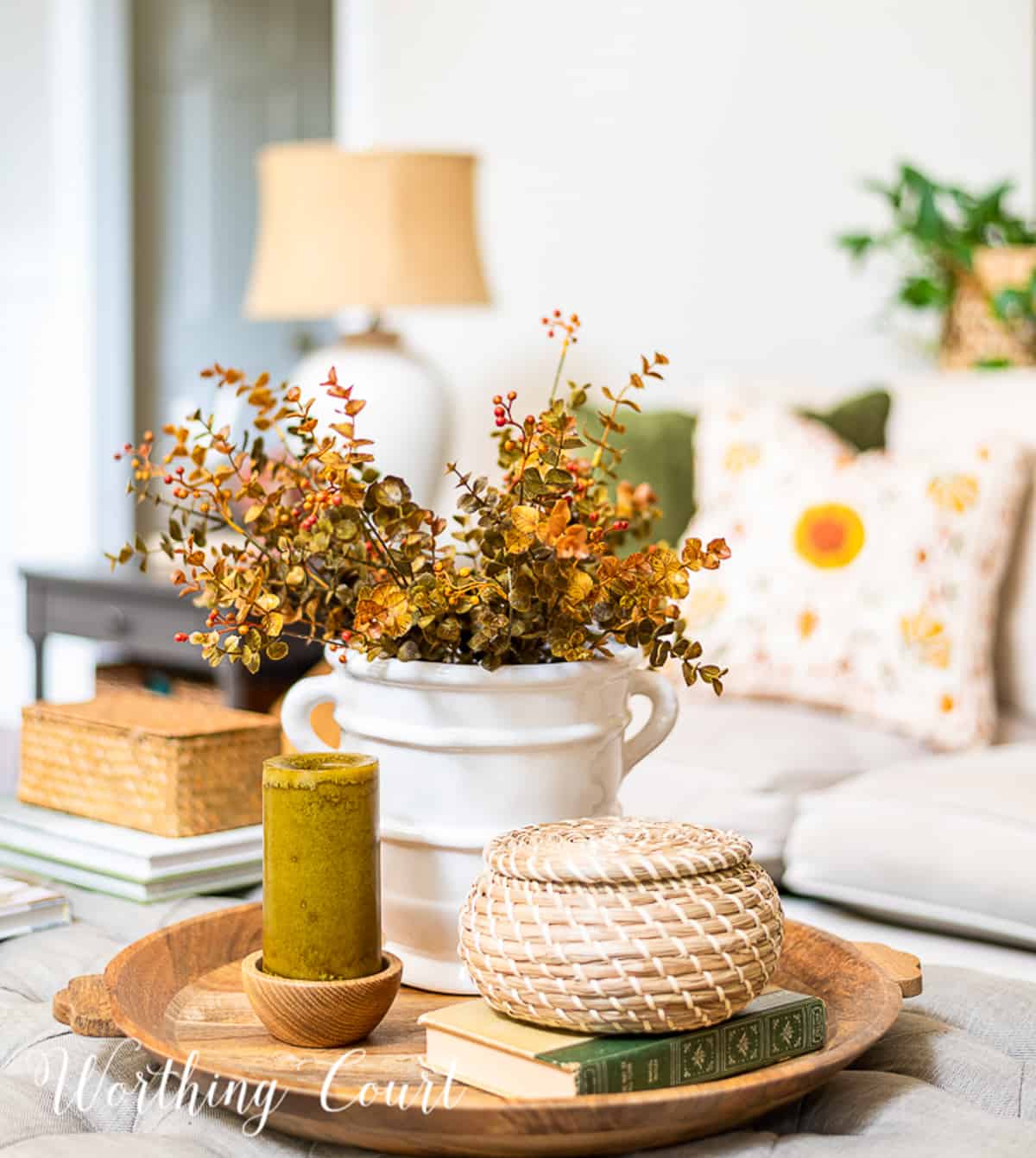 fall vignette on a round wood tray on a coffee table