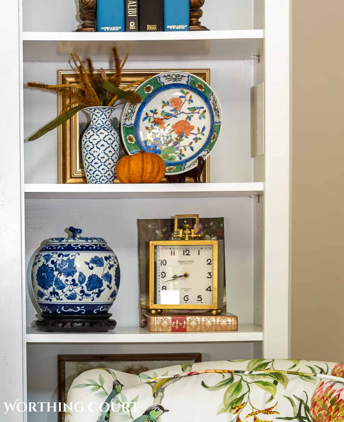 diy fall decorations on the shelves of a white entertainment center