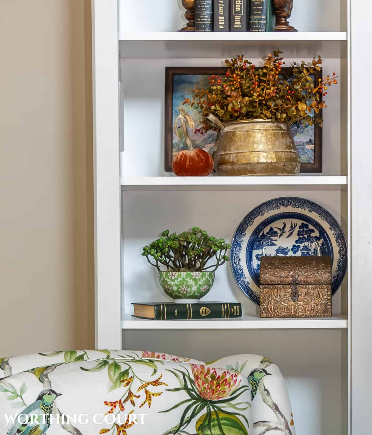 diy fall decorations on the shelves of a white entertainment center